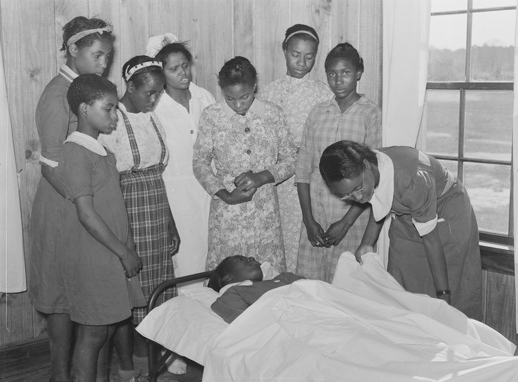 Nurse Shamburg directs a group of girls 